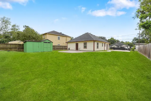 a view of a house with a yard and sitting area