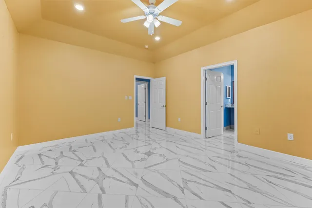 a view of a livingroom with a chandelier fan