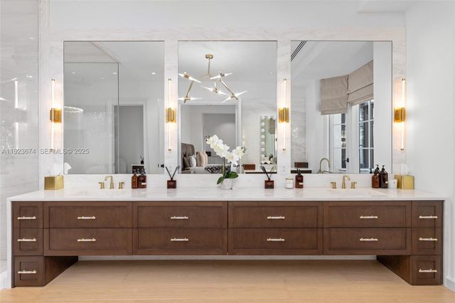 a room with stainless steel appliances kitchen island granite countertop furniture and a chandelier