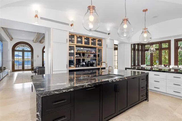 a kitchen with stainless steel appliances a sink stove and cabinets
