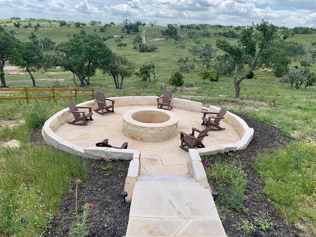 517 Dancing Sun Road Fredericksburg, TX 78624 - Photo 36 of 37 a view of a backyard with table and chairs and garden
