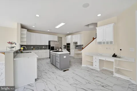 a kitchen with stainless steel appliances granite countertop a stove and a sink