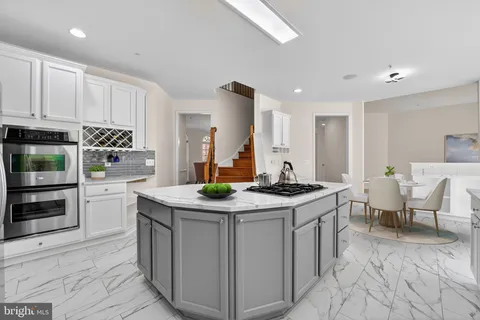 a kitchen with stainless steel appliances granite countertop a sink stove and cabinets