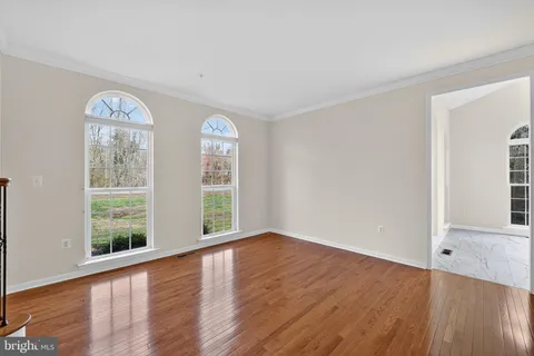 a room with a window and wooden floor