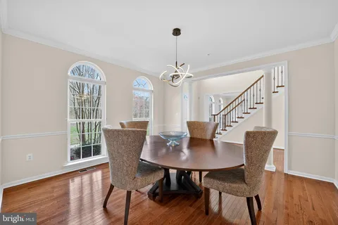 a view of a dining room with furniture wooden floor and a chandelier