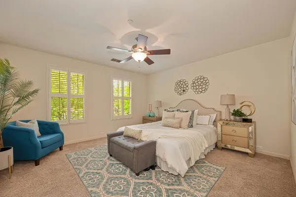 a bedroom with furniture and a large window