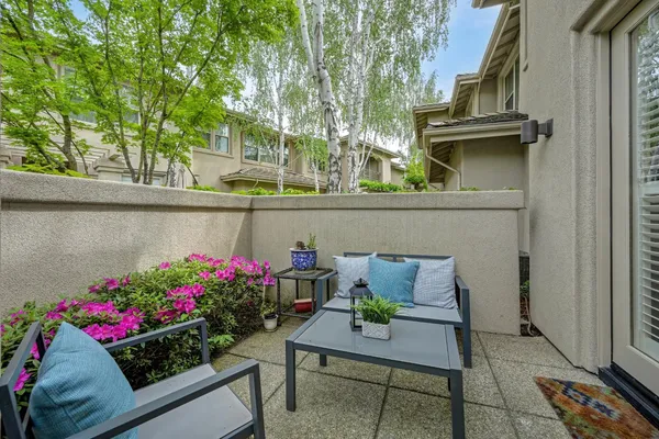 a view of outdoor seating area with flowers and wooden floor