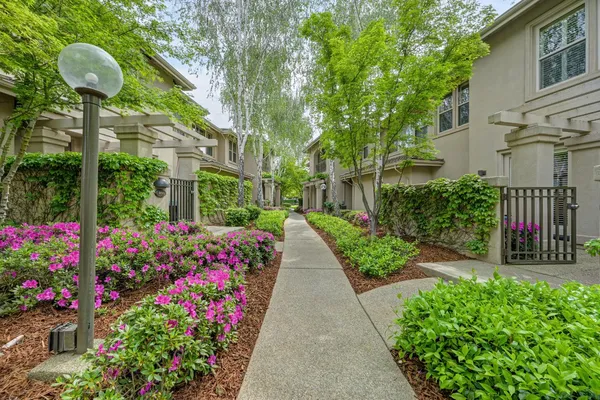 a view of a pathway of a house with a yard