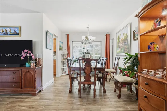 a dining room with furniture and wooden floor