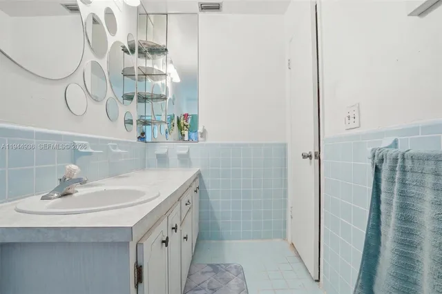 a bathroom with a sink a mirror and a shower