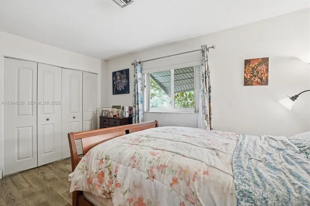 a bedroom with a large bed and a window