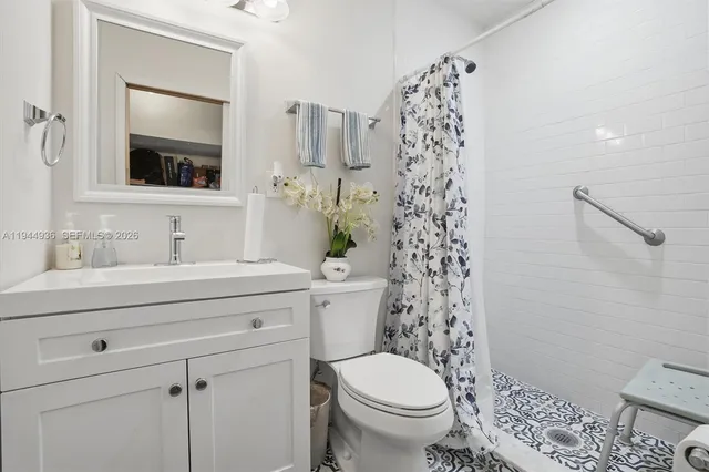 a bathroom with a sink a toilet and shower curtain