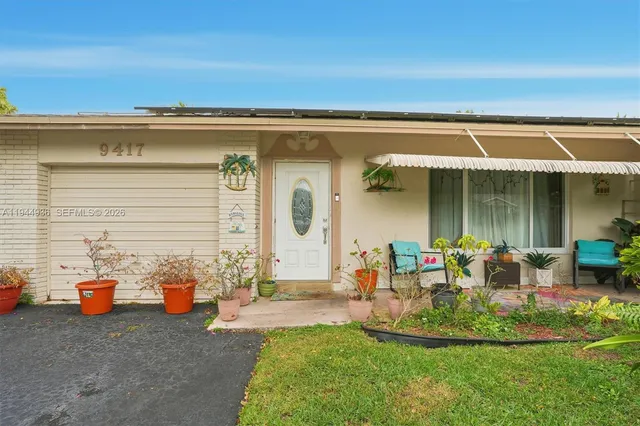 a view of a house with backyard sitting area and garden