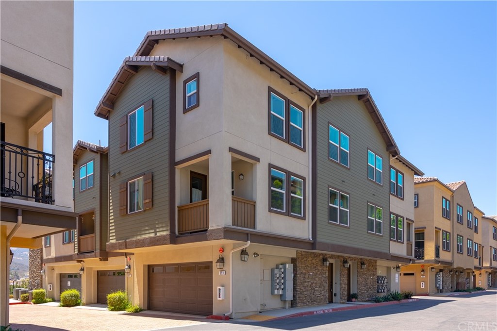 a front view of a residential apartment building with a street