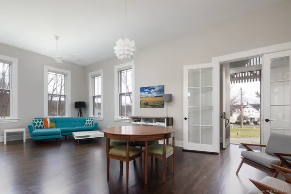 a living room with dining table and a wooden floor