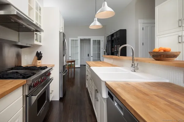 a kitchen with granite countertop a sink and a stove
