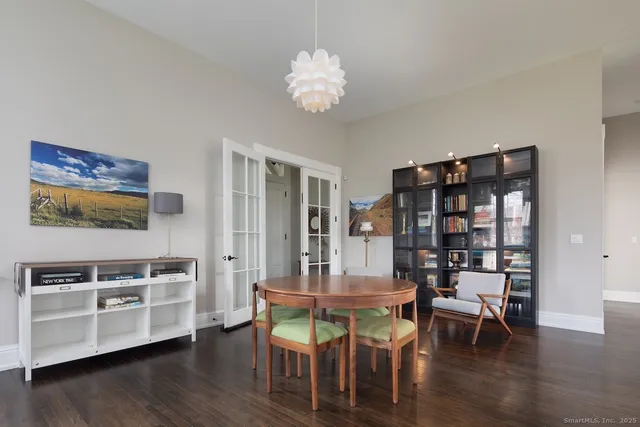 a dining room with furniture and wooden floor