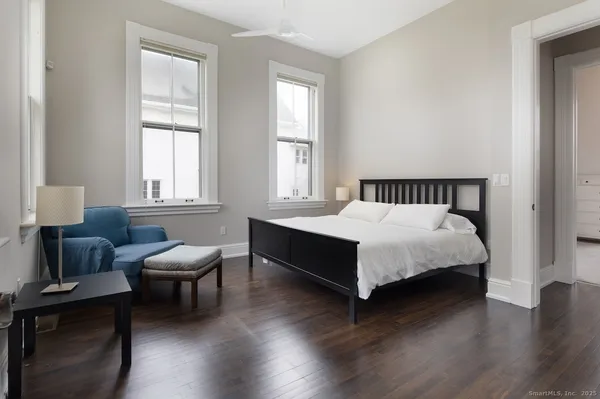 a bed sitting in a bedroom next to a window