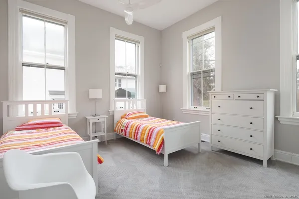 a bedroom with two beds and a window