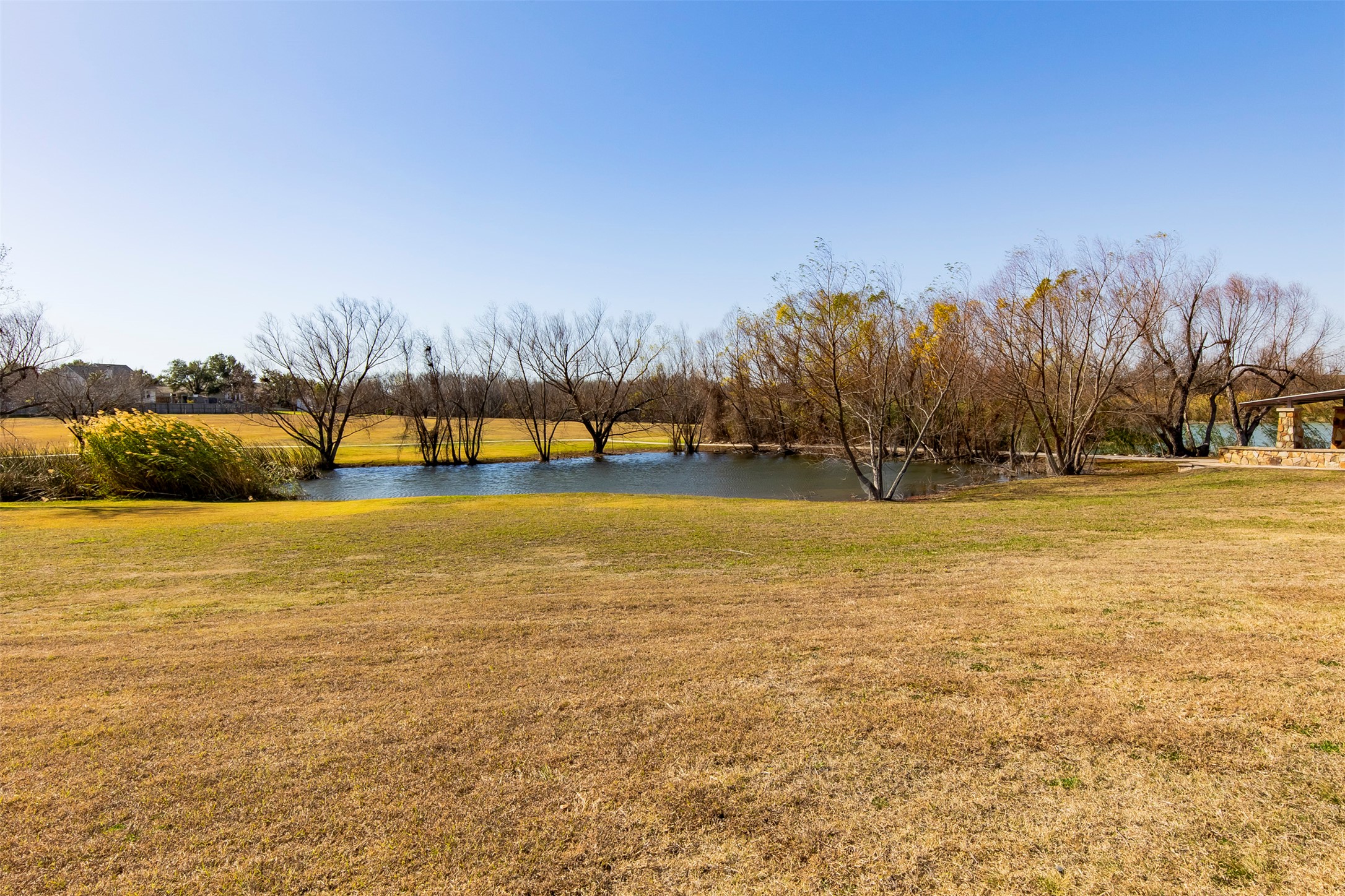 100 Sulphur River Loop Hutto, TX 78634 - Photo 13 of 16 View of green lawn featuring a water view