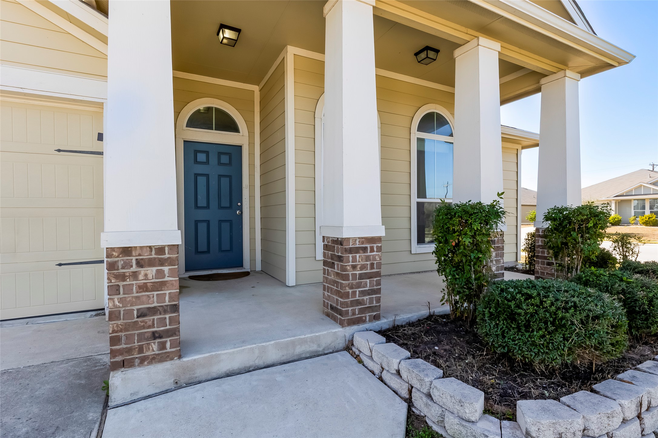 100 Sulphur River Loop Hutto, TX 78634 - Photo 3 of 16 View of exterior entry featuring covered porch and a garage