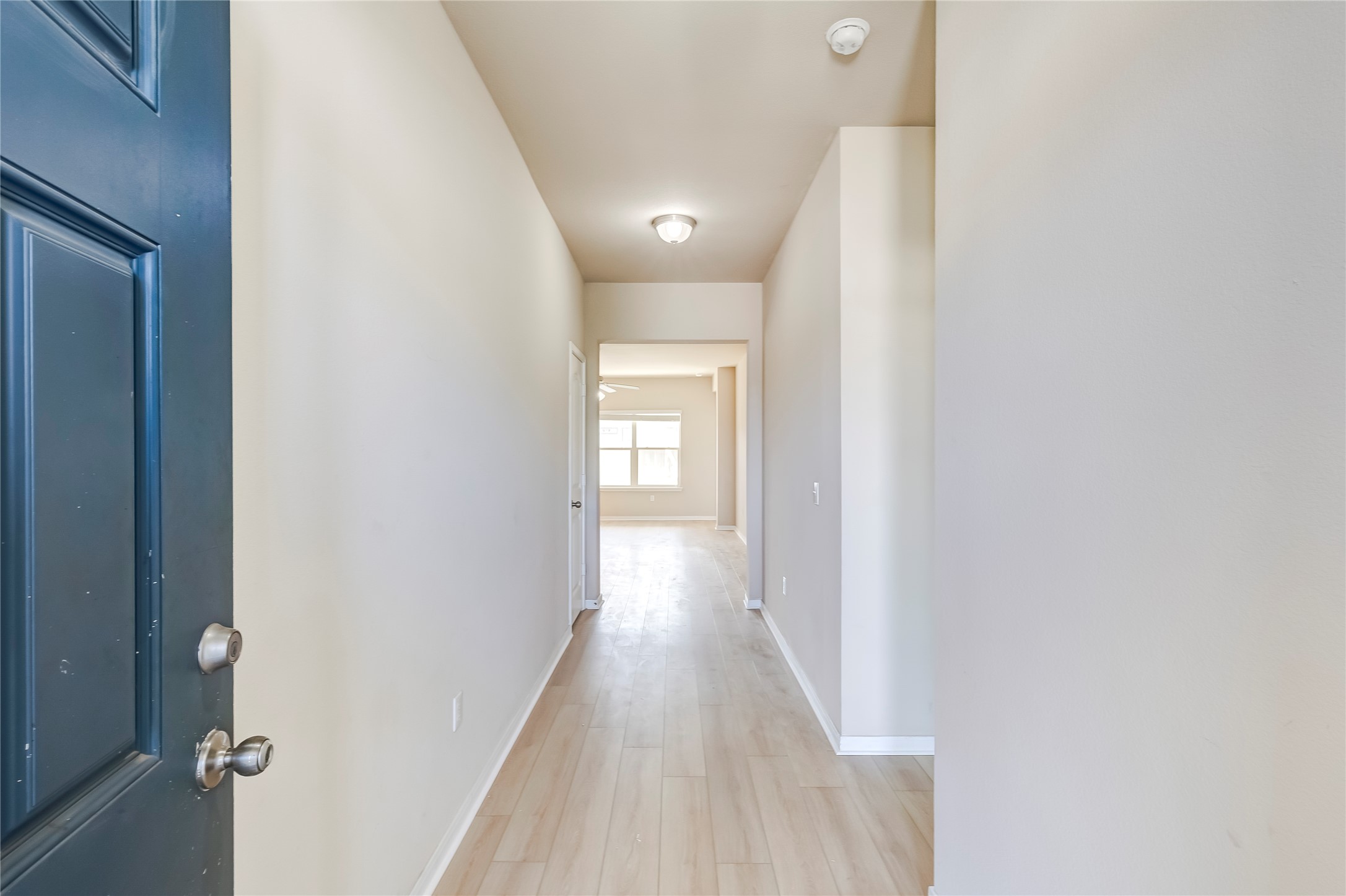 100 Sulphur River Loop Hutto, TX 78634 - Photo 4 of 16 Corridor with baseboards and light wood-style floors