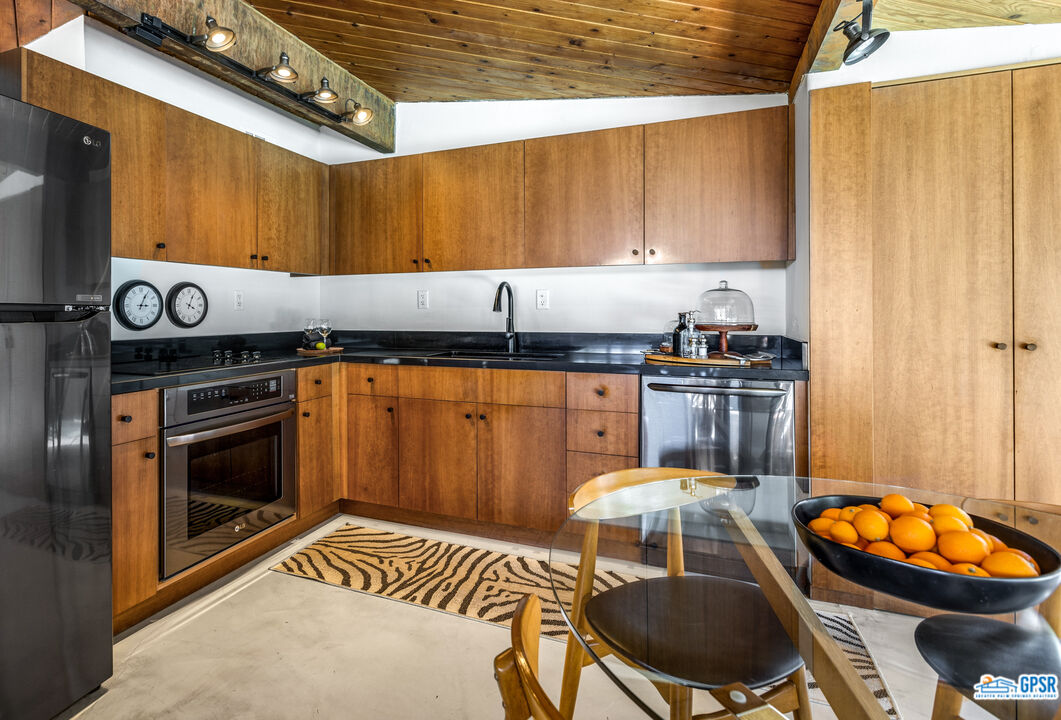 45666 Shadow Mountain Drive Palm Desert, CA 92260 - Photo 18 of 73 a kitchen with stainless steel appliances a stove a sink and cabinets