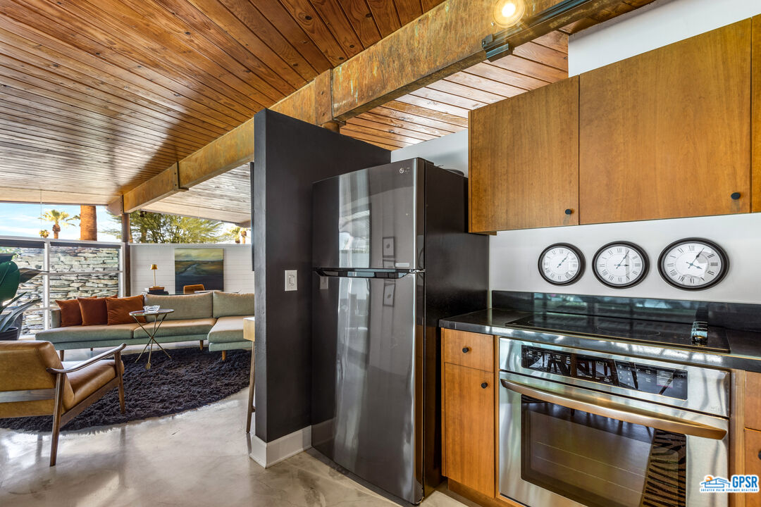 45666 Shadow Mountain Drive Palm Desert, CA 92260 - Photo 21 of 73 a kitchen with a stove a refrigerator and cabinets