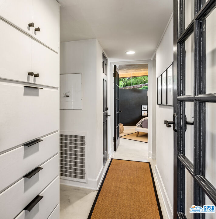 45666 Shadow Mountain Drive Palm Desert, CA 92260 - Photo 23 of 73 a view of a hallway with wooden floor and staircase