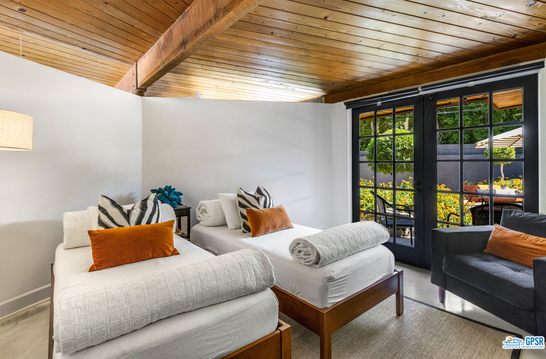 45666 Shadow Mountain Drive Palm Desert, CA 92260 - Photo 25 of 73 a bedroom with furniture and large windows