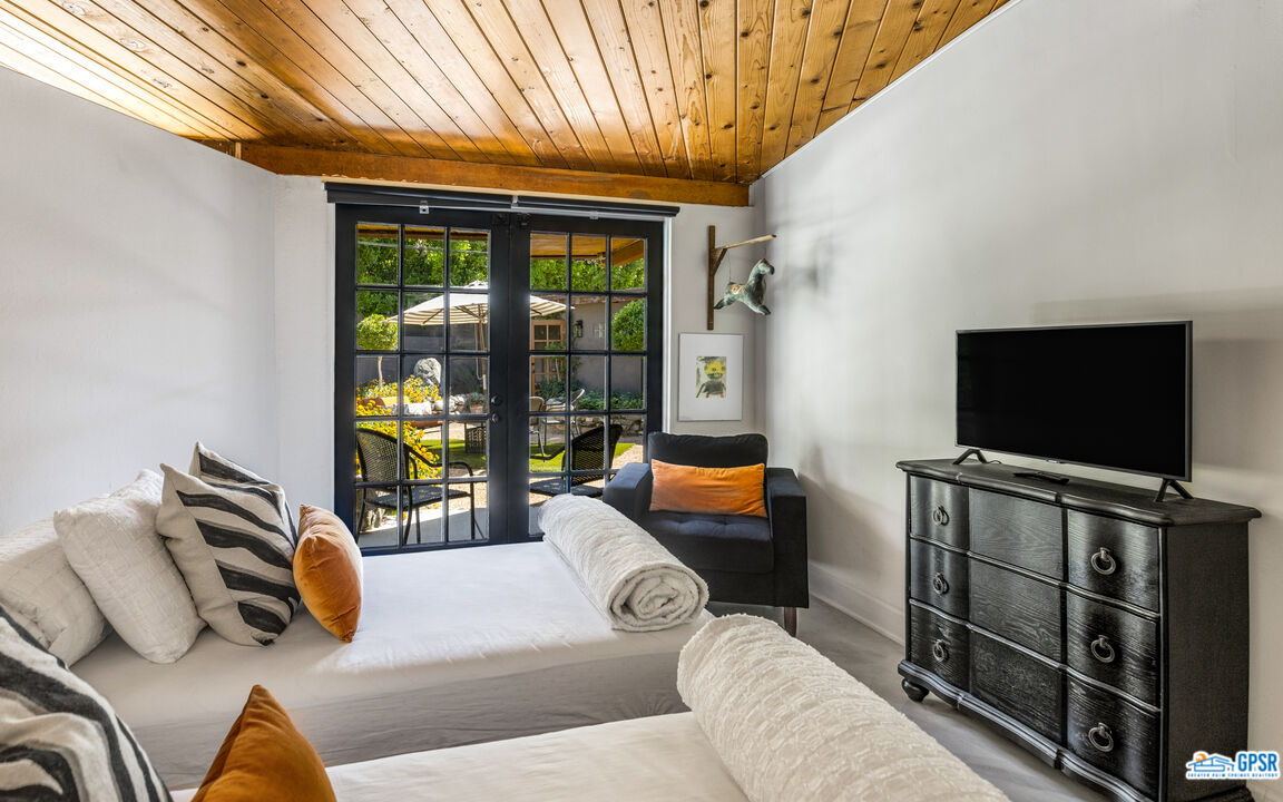 45666 Shadow Mountain Drive Palm Desert, CA 92260 - Photo 27 of 73 a living room with furniture and a flat screen tv