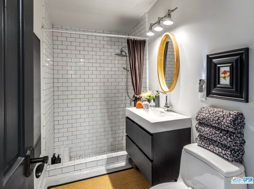 45666 Shadow Mountain Drive Palm Desert, CA 92260 - Photo 28 of 73 a bathroom with a sink toilet and shower