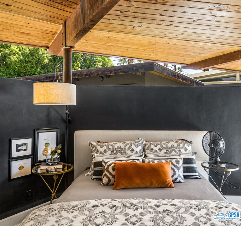 45666 Shadow Mountain Drive Palm Desert, CA 92260 - Photo 30 of 73 a bedroom with a bed and wooden floor