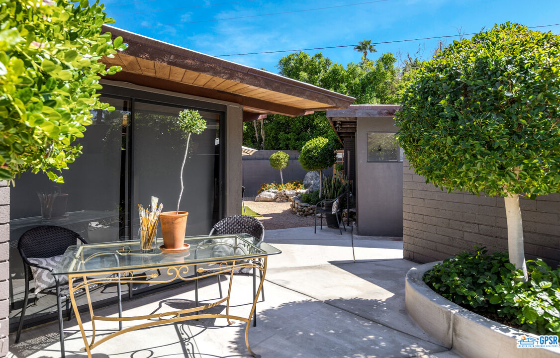 45666 Shadow Mountain Drive Palm Desert, CA 92260 - Photo 41 of 73 a patio with table and chairs and potted plants