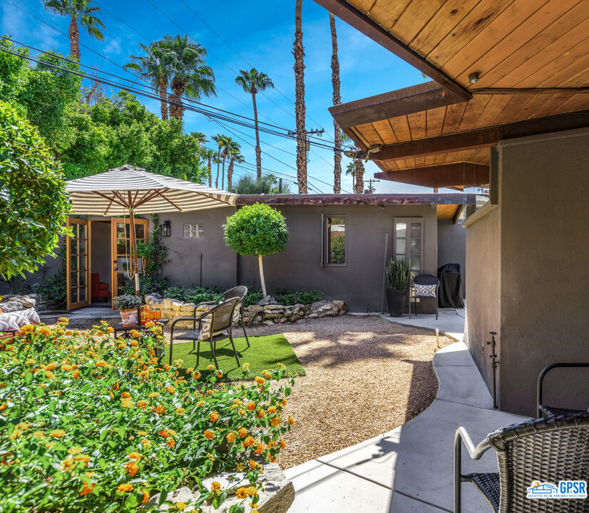 45666 Shadow Mountain Drive Palm Desert, CA 92260 - Photo 45 of 73 a patio with a table and chairs under an umbrella