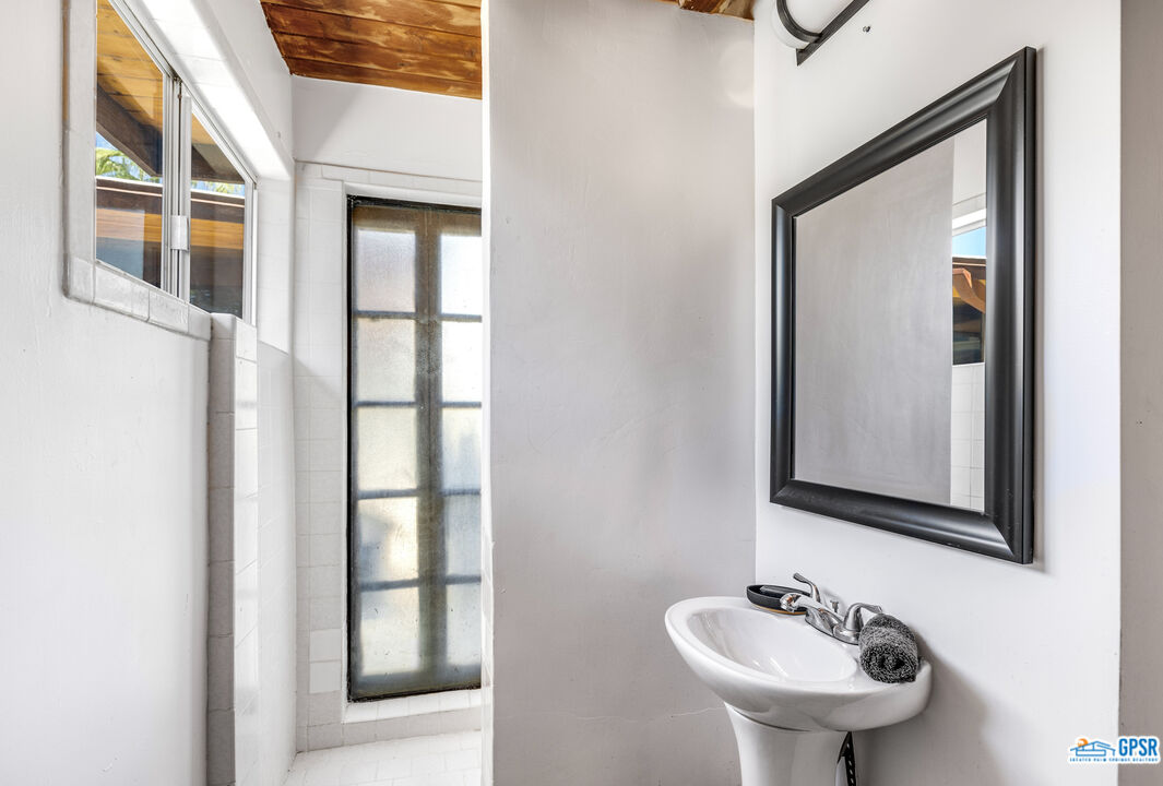 45666 Shadow Mountain Drive Palm Desert, CA 92260 - Photo 54 of 73 a bathroom with a sink and a mirror
