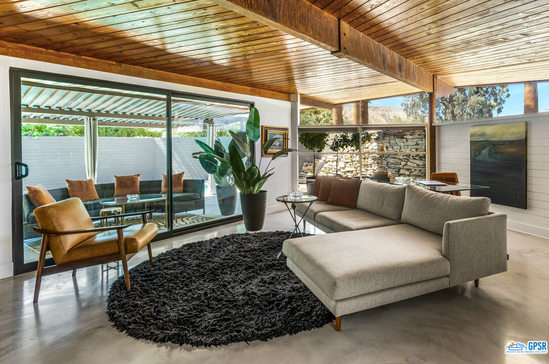 45666 Shadow Mountain Drive Palm Desert, CA 92260 - Photo 9 of 73 a living room with furniture and a large window