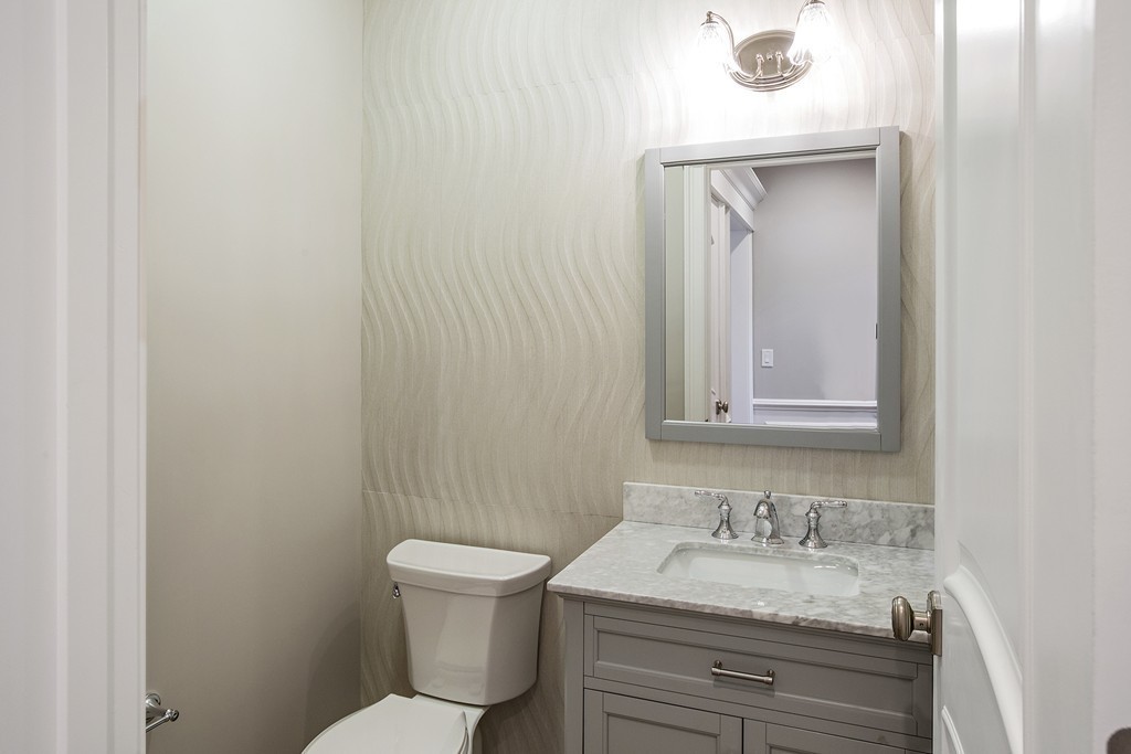 6 Johnson Road Winchester, MA 01890 - Photo 15 of 30 a bathroom with a toilet sink vanity and mirror