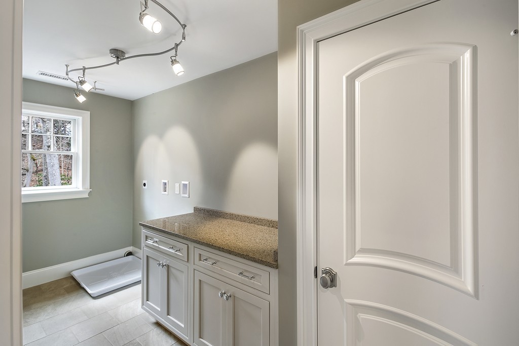 6 Johnson Road Winchester, MA 01890 - Photo 23 of 30 a bathroom with a granite countertop sink and a mirror