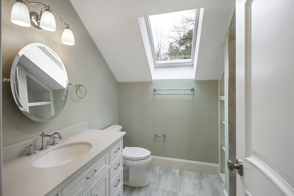 6 Johnson Road Winchester, MA 01890 - Photo 25 of 30 a bathroom with a granite countertop toilet sink and mirror