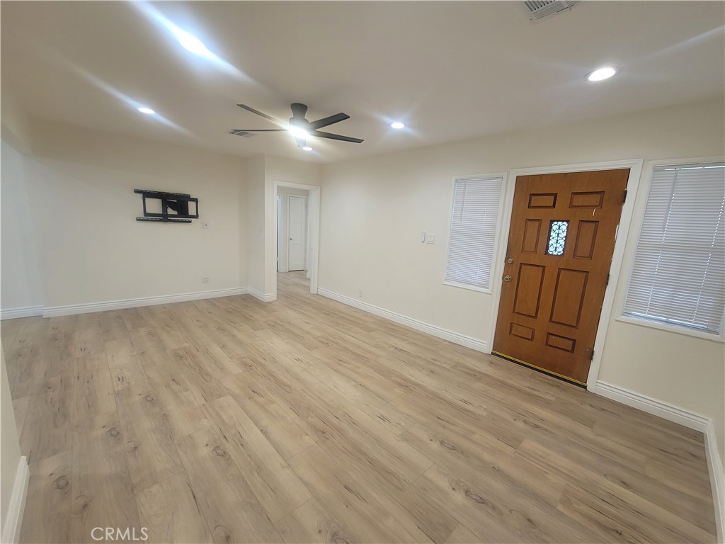 8907 Boyar Avenue Whittier, CA 90605 - Photo 2 of 16 an empty room with wooden floor and windows