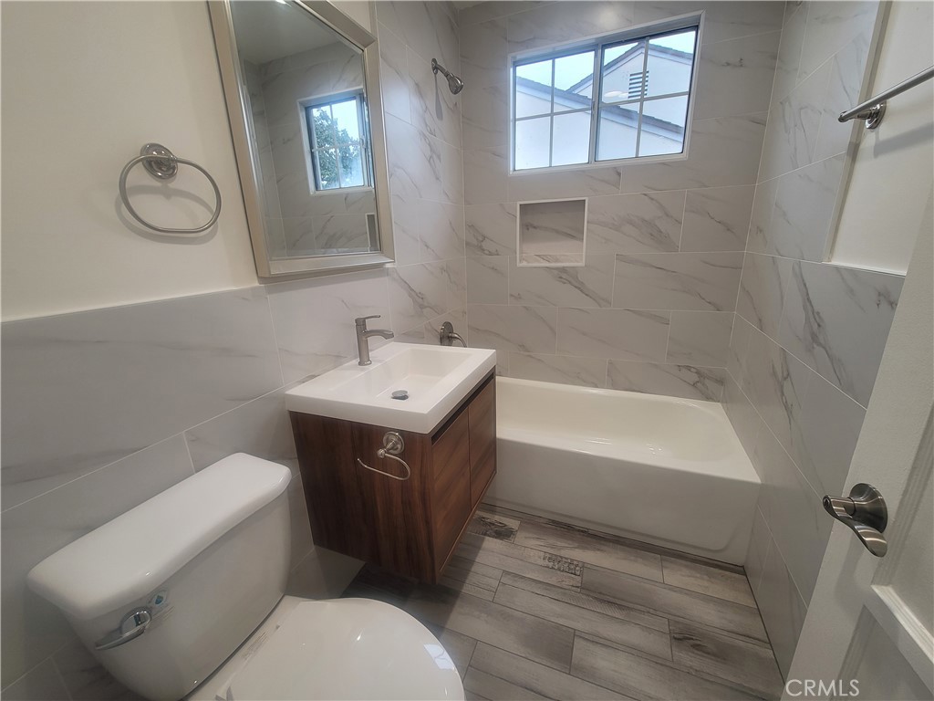 8907 Boyar Avenue Whittier, CA 90605 - Photo 7 of 16 a bathroom with a sink a toilet and a bathtub