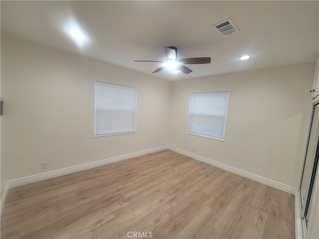 8907 Boyar Avenue Whittier, CA 90605 - Photo 10 of 16 an empty room with wooden floor and windows