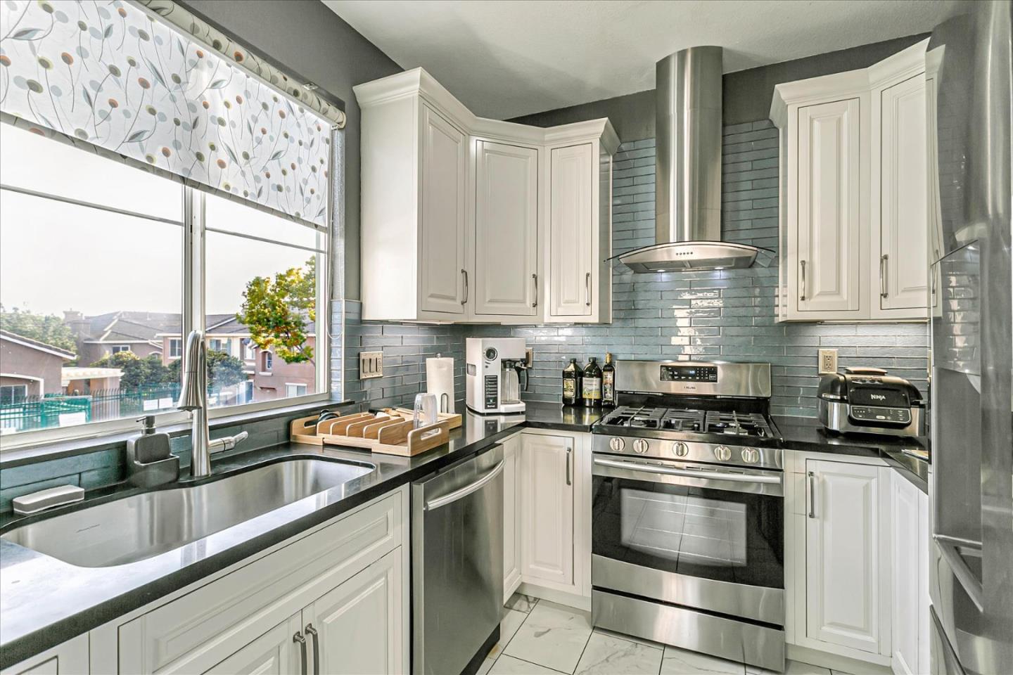 3657 Jasmine Circle San Jose, CA 95135 - Photo 14 of 62 a kitchen with granite countertop a sink stainless steel appliances and cabinets