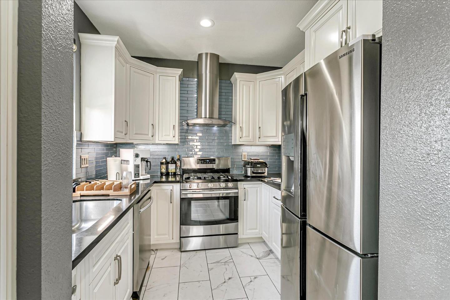 3657 Jasmine Circle San Jose, CA 95135 - Photo 15 of 62 a kitchen with stainless steel appliances granite countertop a refrigerator a stove and a sink