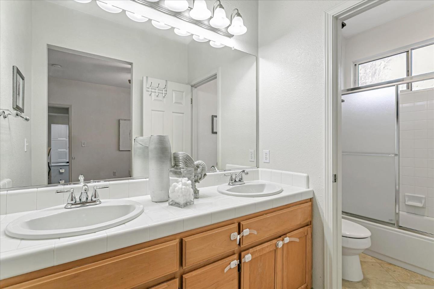 3657 Jasmine Circle San Jose, CA 95135 - Photo 23 of 62 a bathroom with a granite countertop sink mirror and toilet