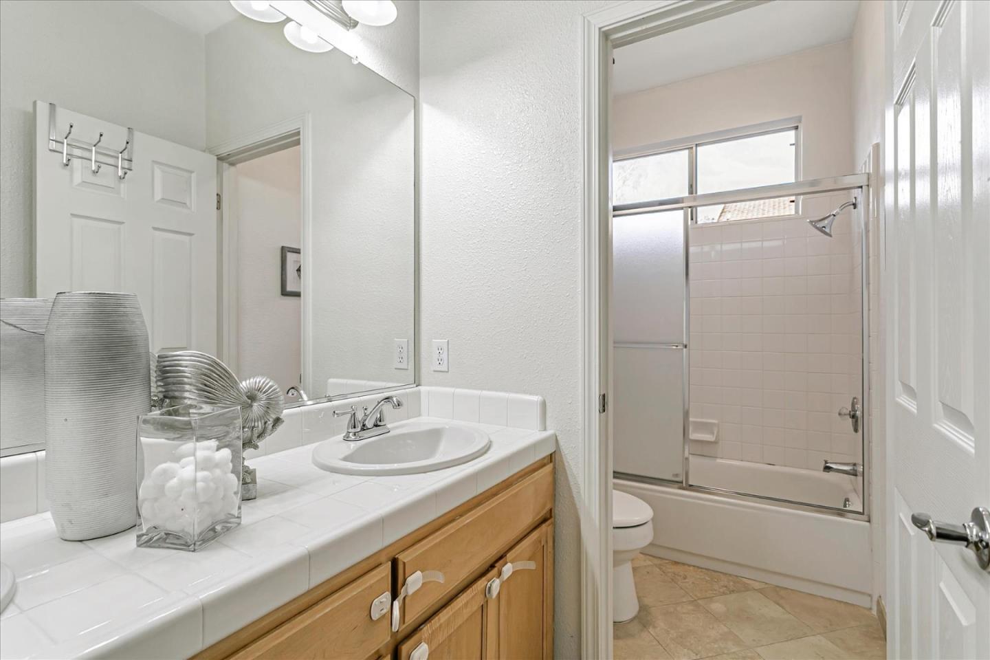 3657 Jasmine Circle San Jose, CA 95135 - Photo 24 of 62 a bathroom with a granite countertop sink a toilet and shower