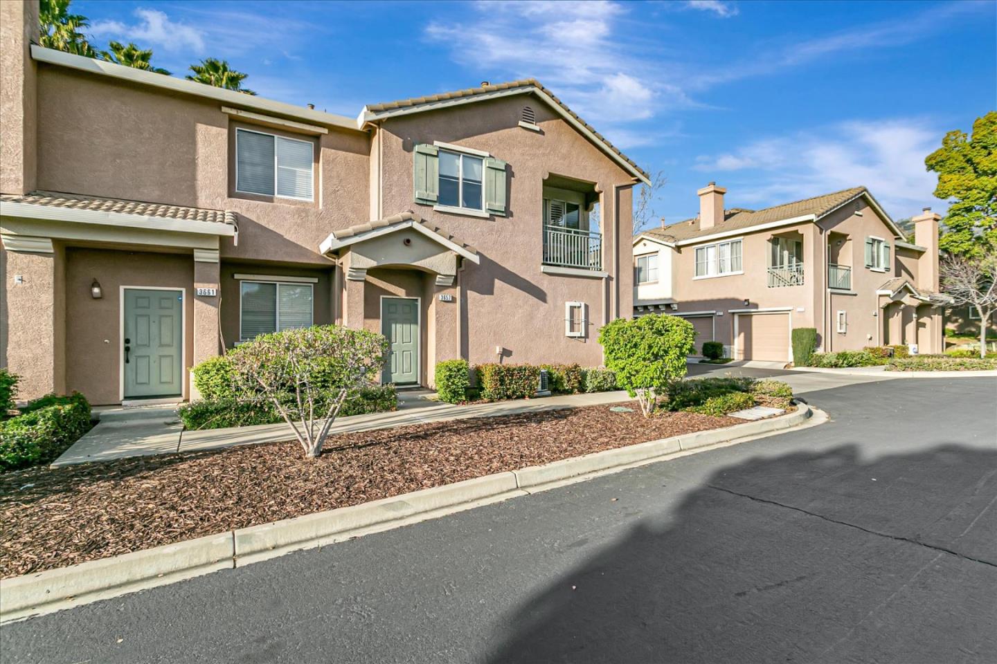 3657 Jasmine Circle San Jose, CA 95135 - Photo 7 of 62 a front view of a house with a yard and garage