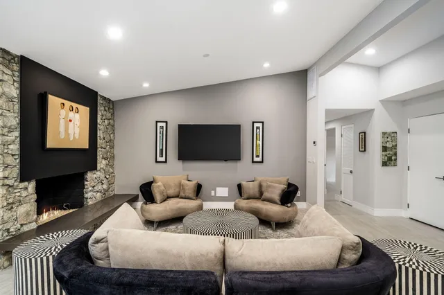 a kitchen with stainless steel appliances kitchen island granite countertop a dining table chairs and sink