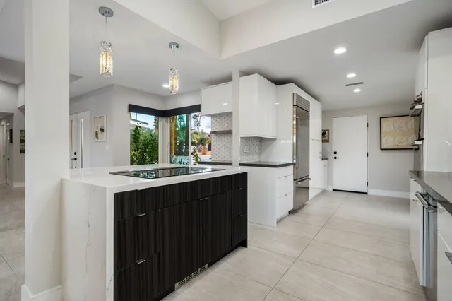 a kitchen with refrigerator and furniture